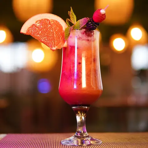 Pink grapefruit mocktail under glowing lanterns