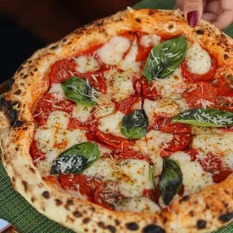 Wood-fired margherita pizza with basil