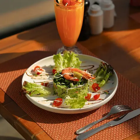 Prawn salad with a fresh orange juice
