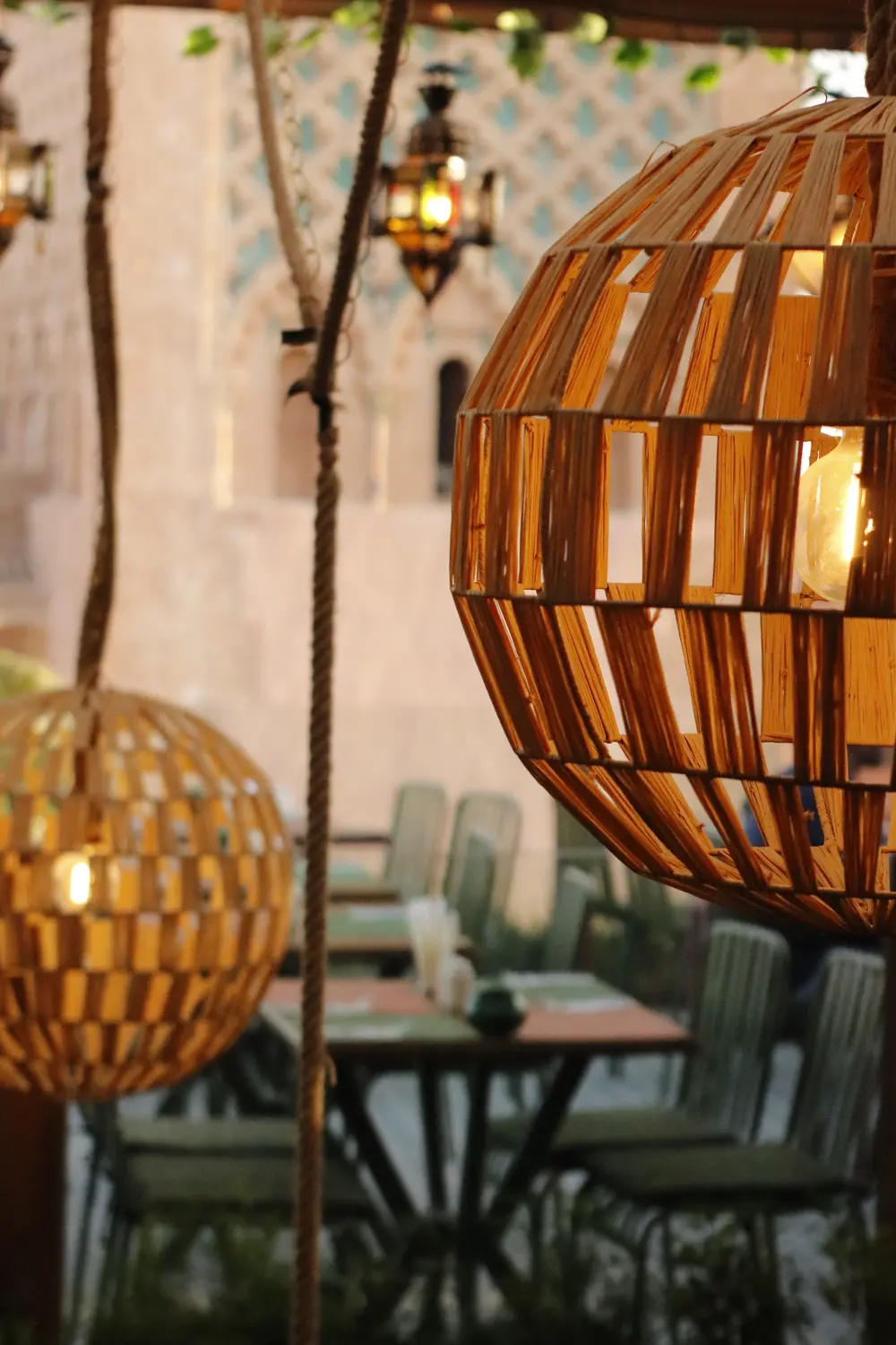The rooftop terrace at night, lit by a woven pendant lantern