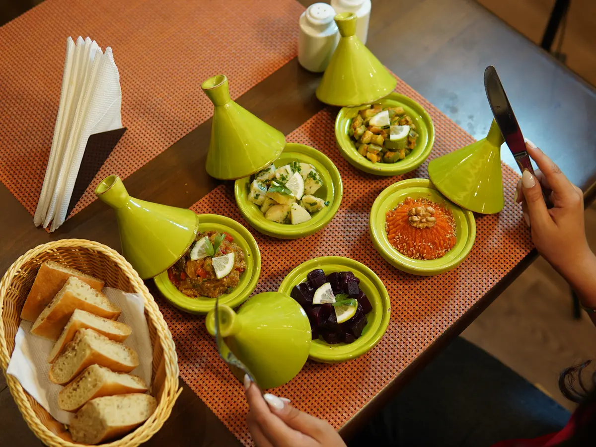 Moroccan salads served in small bowls with green tagine lids